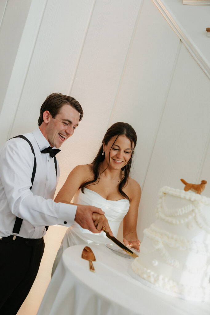 Bride and groom cutting their wedding cake together. 