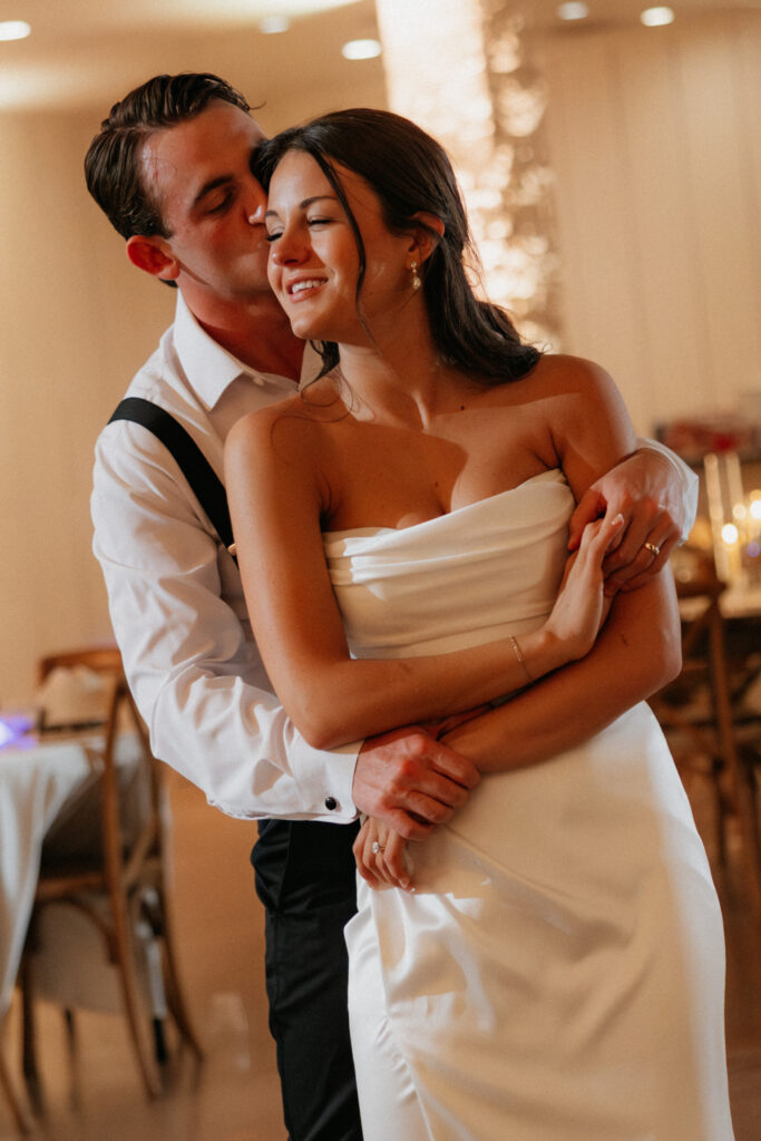 Bride and groom dancing together. 
