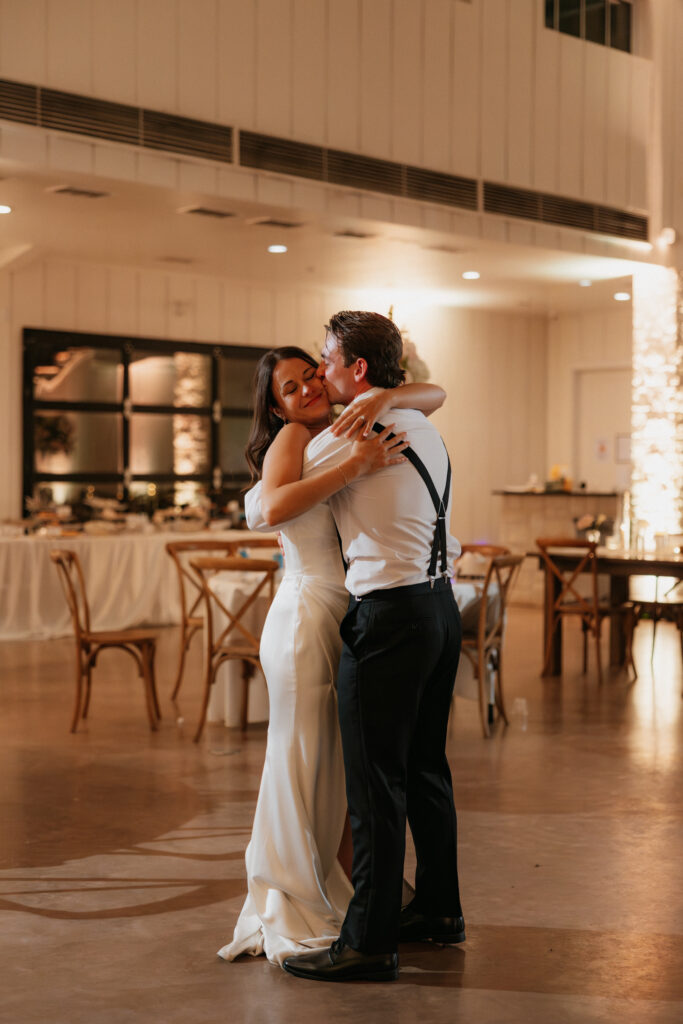Bride and groom slow dancing at the end of their wedding night.