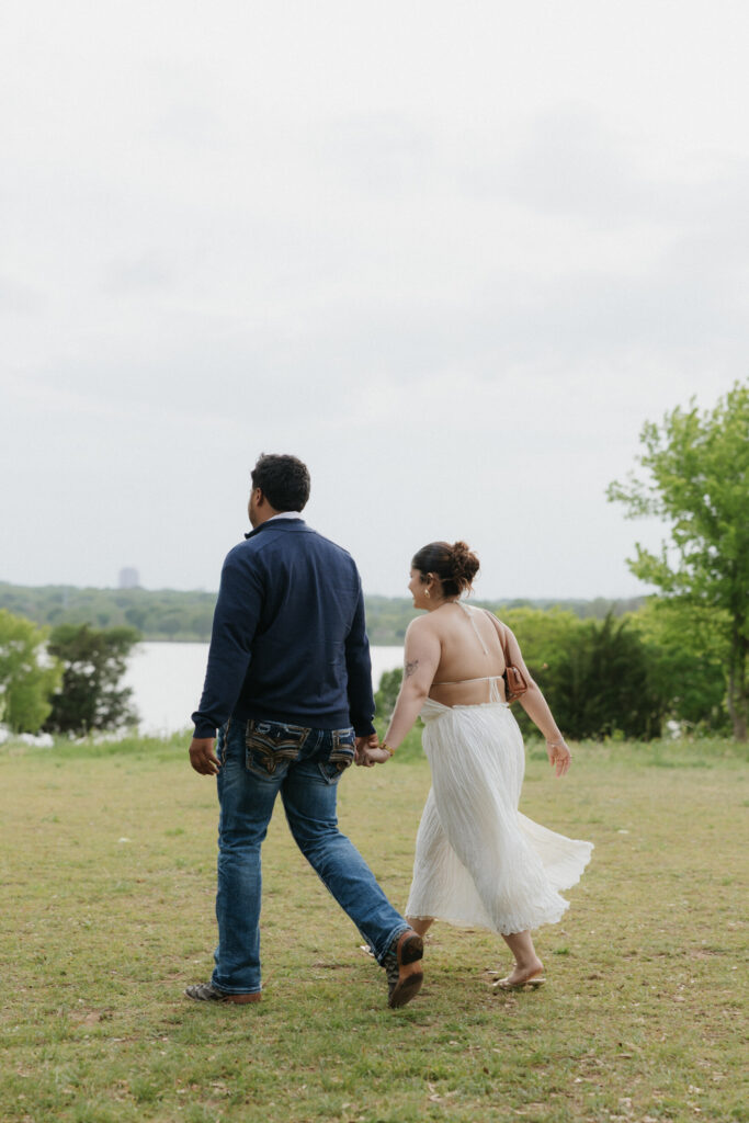 Couple walking towards their Winfrey Point proposal setup.