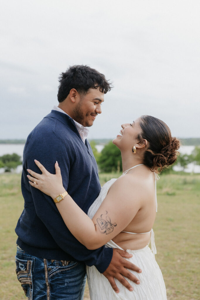 Couple smiling at one another romantically at Winfrey Point Dallas.