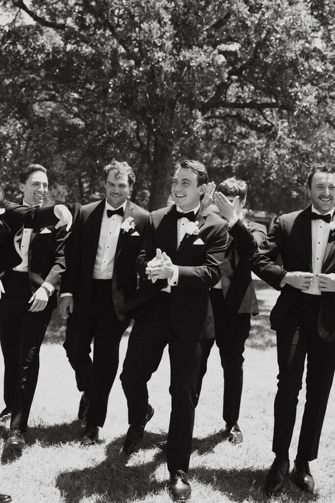 Groomsmen walking and smiling.