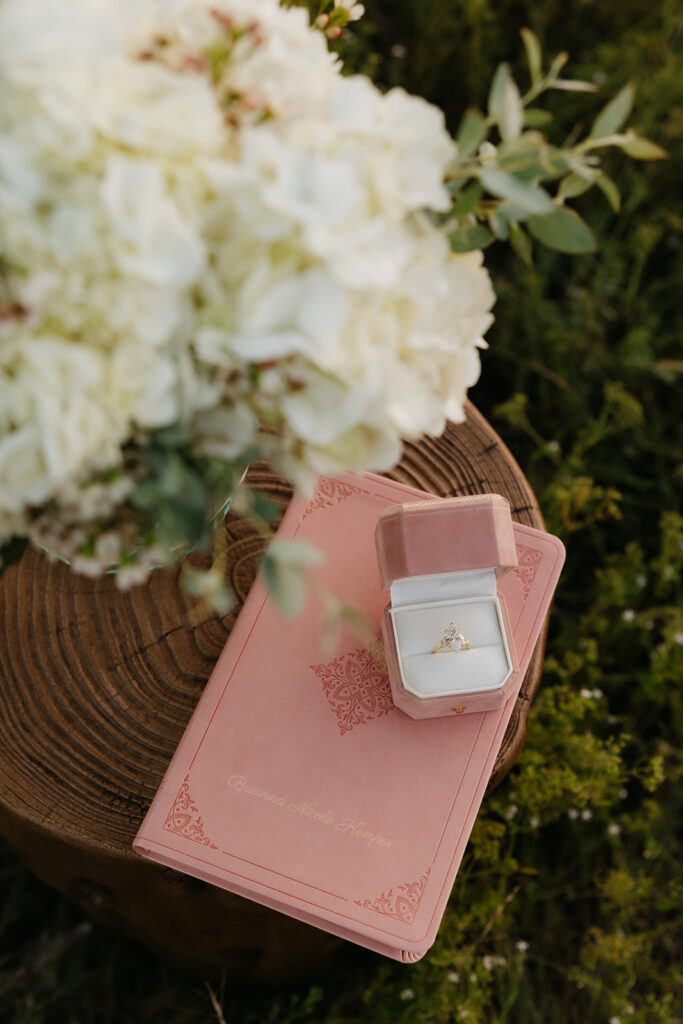 Romantic outdoor proposal ideas of an engraved Bible and ring box.