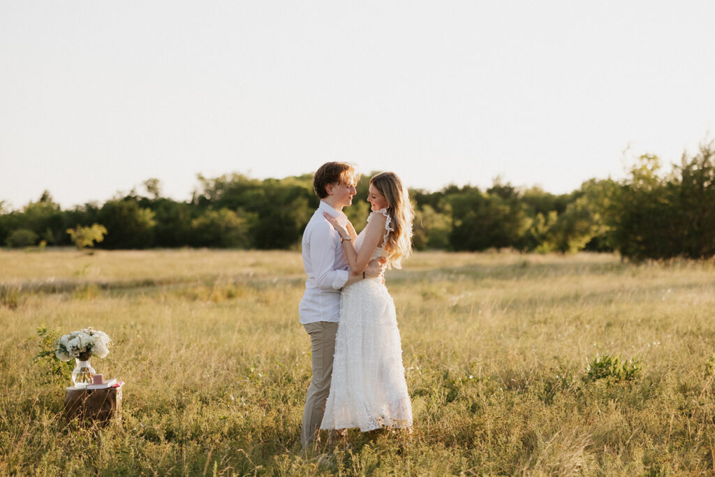 Couple holding one another during the outdoor proposal.