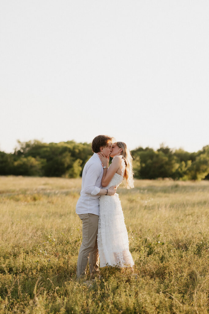 Couple kissing during their golden hour engagement photoshoot. 