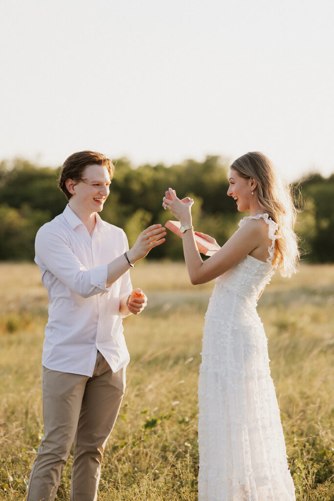 Couple smiling together as they admire the outdoor proposal ideas . 