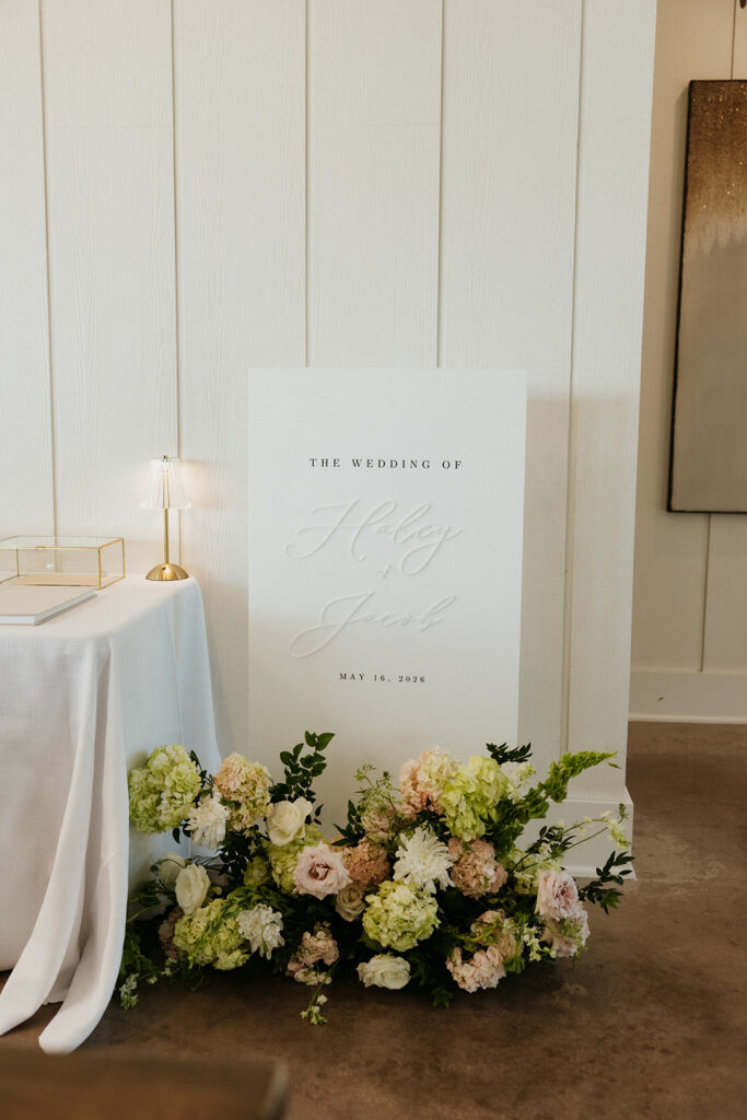 Elegant spring wedding flowers and signage.