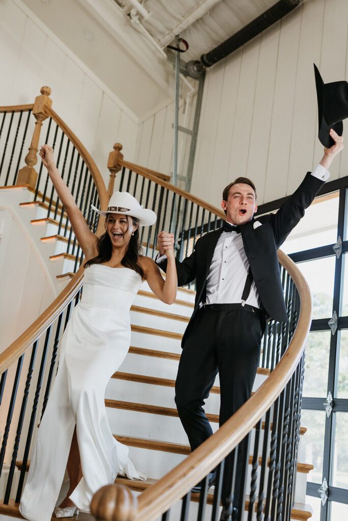 Bride and groom entering the North Texas wedding venue with western hats on.