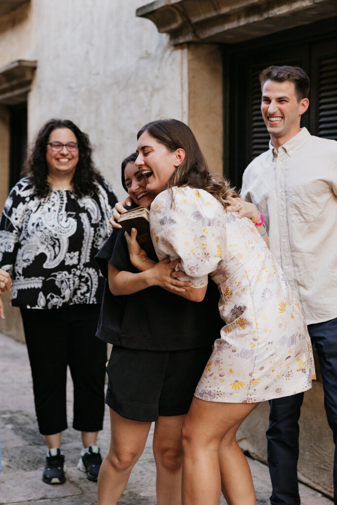 Engaged woman hugging a family member.