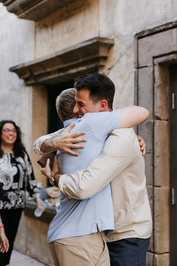Man hugging a family member. 
