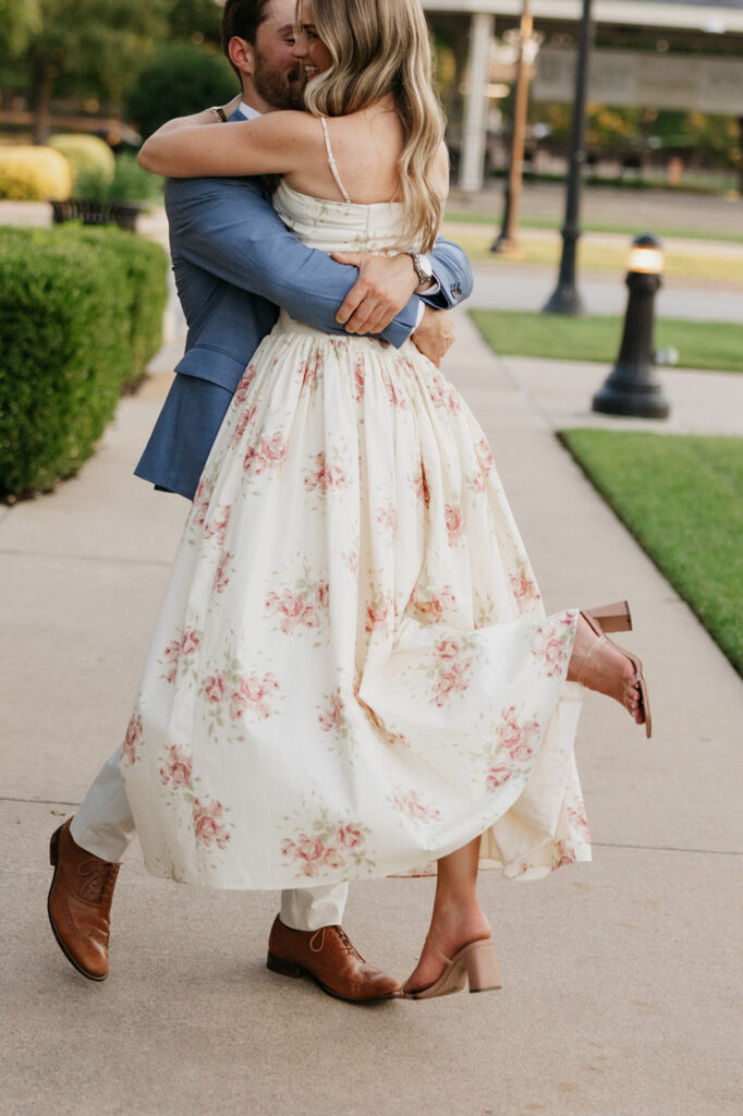 Man spinning his fiancée during their surprise proposal.