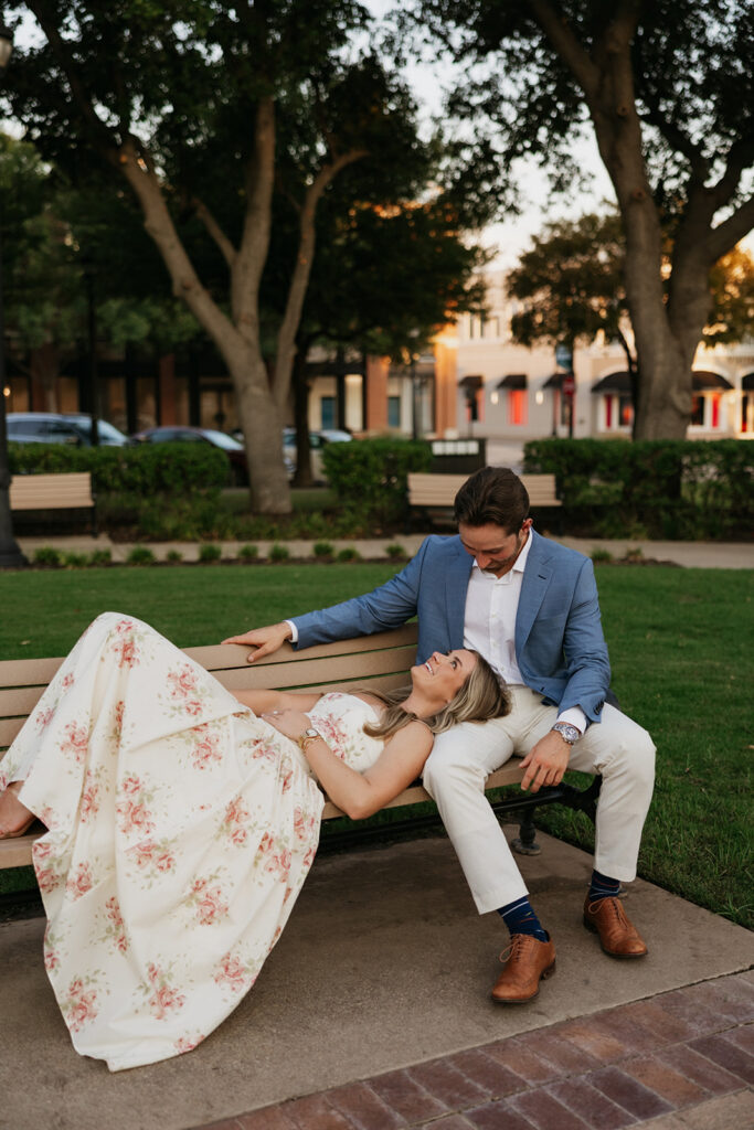 Woman laying on a bench at Lakeside Town Square.